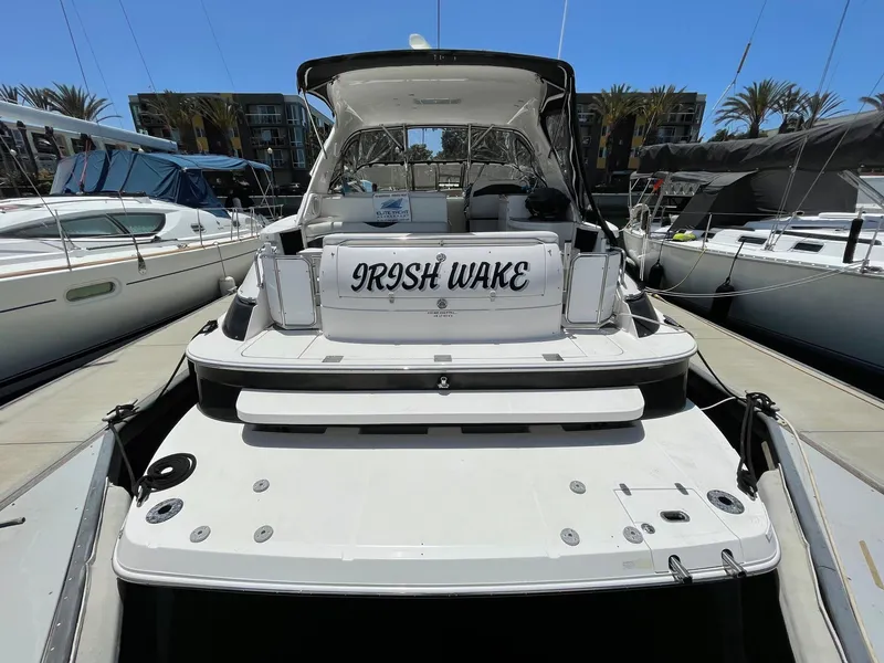 Slide: The Image of 2005 Regal 4260 COMMODORE yacht docked, rear view with "Irish Wake" nameplate. - 6