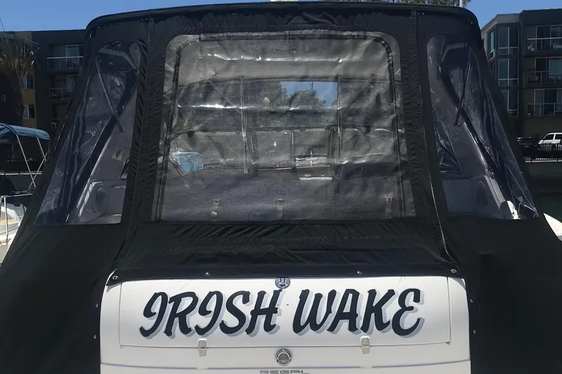 Slide: The Image of 2005 Regal 4260 Commodore boat named "Irish Wake" with black canopy. - 7