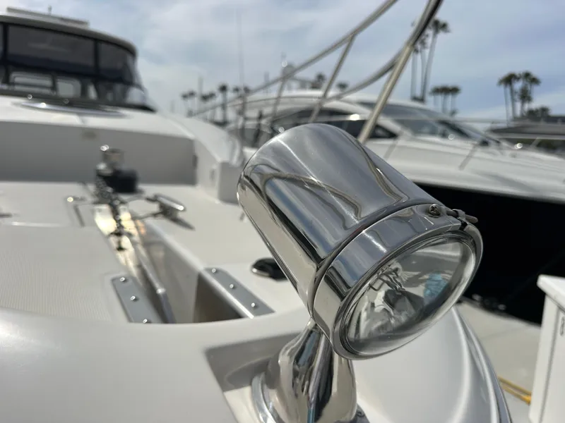 Slide: The Image of 2005 Regal 4260 COMMODORE yacht with chrome spotlight, docked in marina. - 9