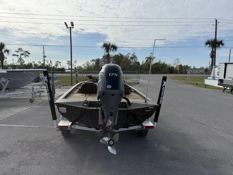 Slide: The Image of 2025 Xpress Hyper-Lift Bass Series boat on trailer, rear view, outdoor setting. - 3