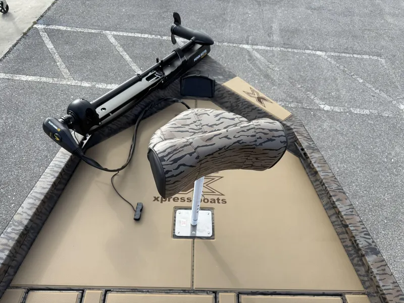 Slide: The Image of 2025 Xpress Hyper-Lift Bass Series boat with camo seat and trolling motor. - 4