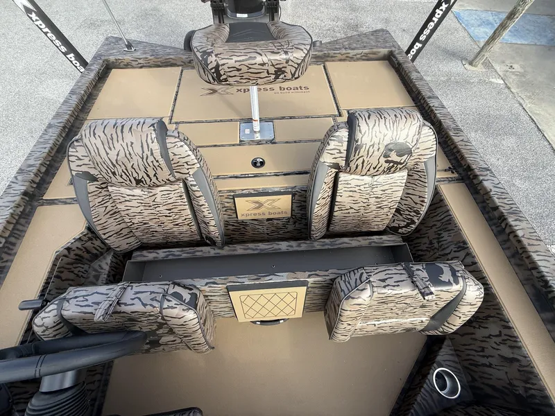 Slide: The Image of 2025 Xpress Hyper-Lift Bass Series boat interior with camouflage seats and steering wheel. - 9