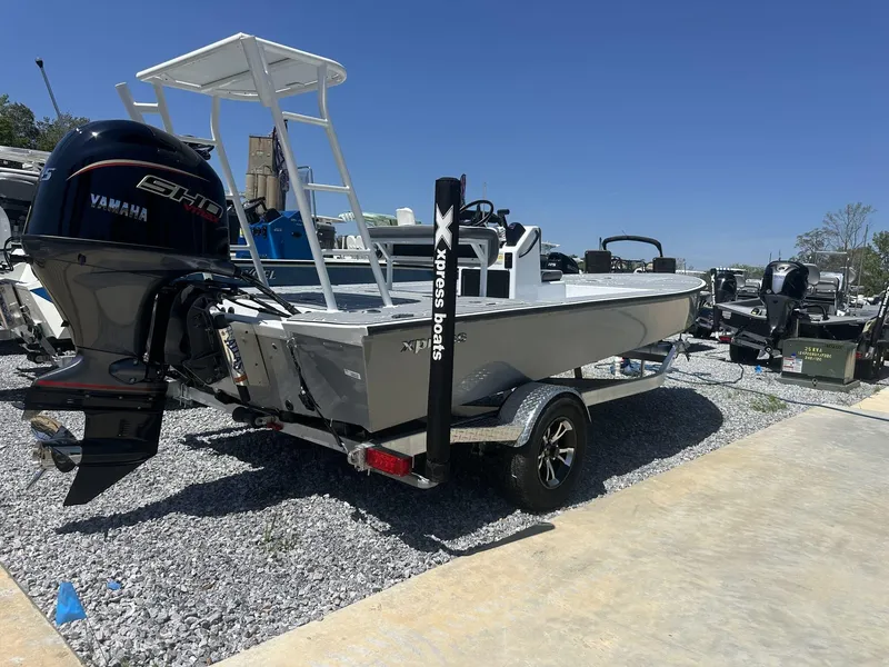 Slide: The Image of 2025 Xpress Skiff 185 boat with Yamaha engine on trailer, parked outdoors. - 9
