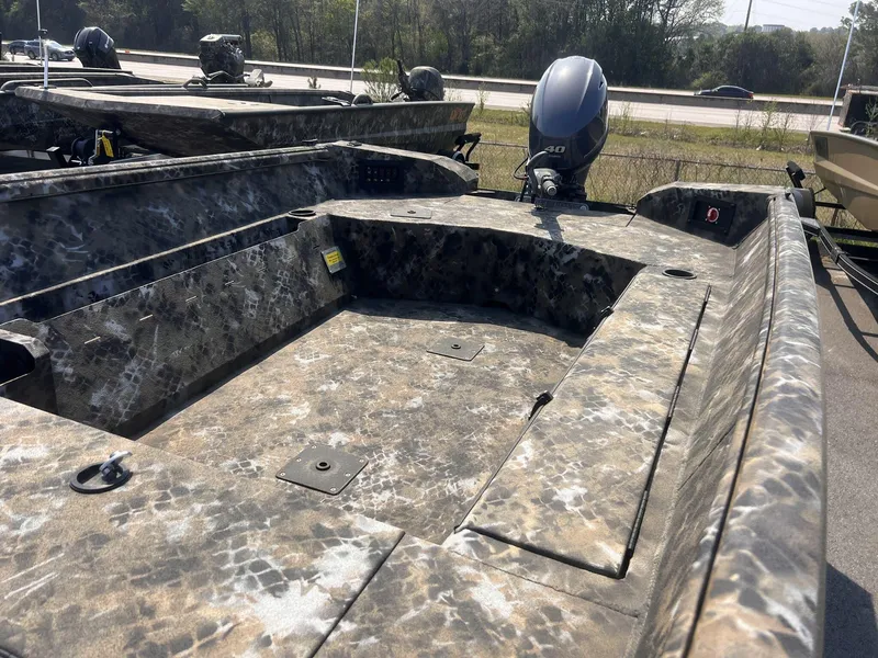 Slide: The Image of 2024 Excel RIVER WARRIOR 1651 boat with camouflage design and outboard motor. - 3