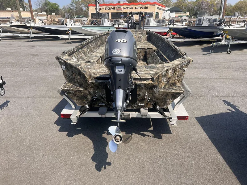 Slide: The Image of 2024 Excel RIVER WARRIOR 1651 boat with camouflage design and outboard motor. - 6