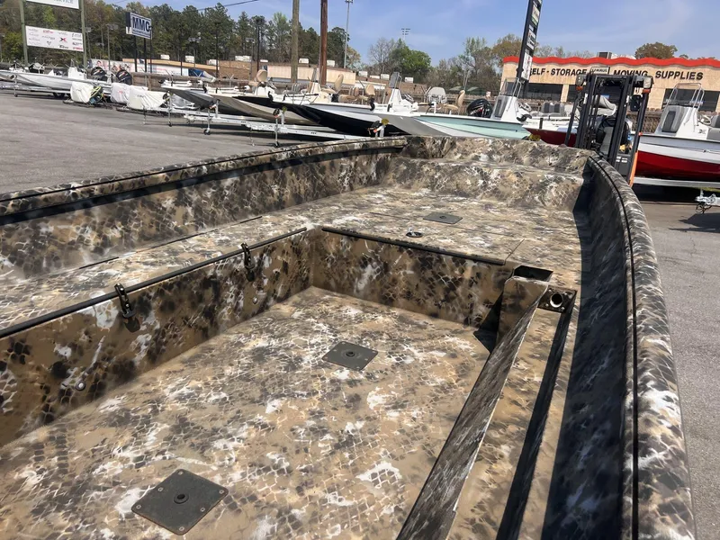 Slide: The Image of 2024 Excel RIVER WARRIOR 1651 boat with camouflage design in a dealership lot. - 7