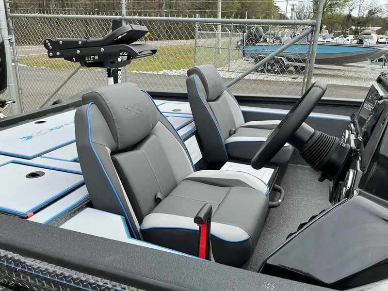 Slide: The Image of 2025 Xpress Hyper-Lift Crappie Series H20 boat interior with dual seats and steering console. - 3