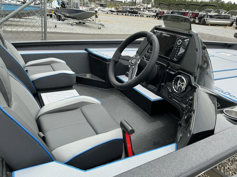 Slide: The Image of 2025 Xpress Hyper-Lift Crappie Series H20 boat interior with steering console and seating. - 8