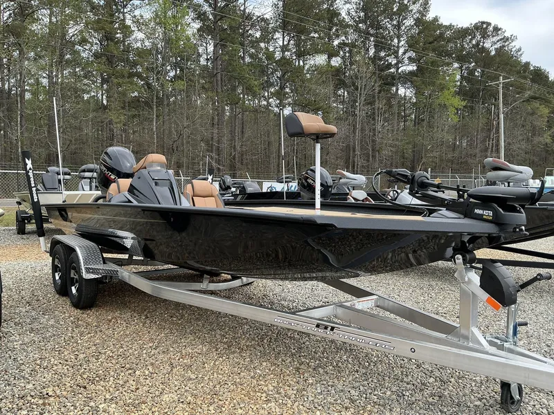 Slide: The Image of 2025 Xpress Hyper-Lift Bass Series boat on trailer, parked outdoors. - 1