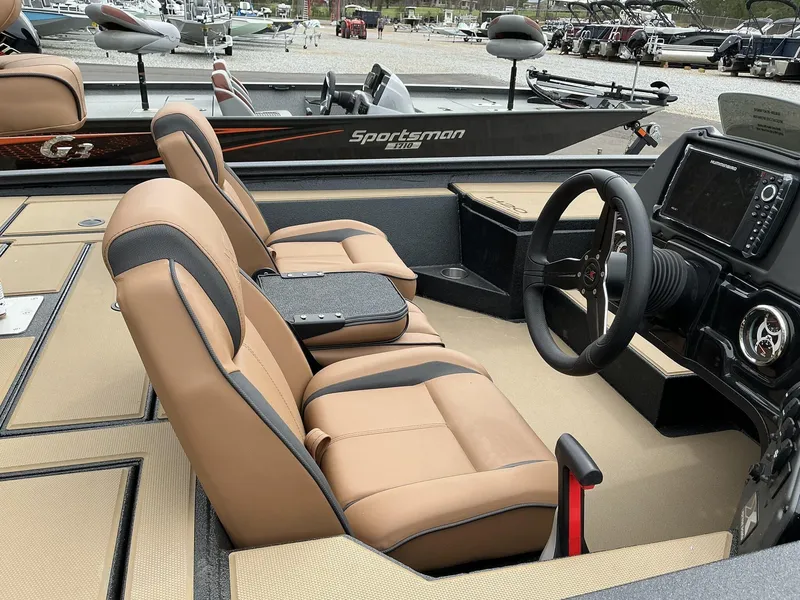 Slide: The Image of 2025 Xpress Hyper-Lift Bass Series boat interior with tan seats and modern dashboard. - 3
