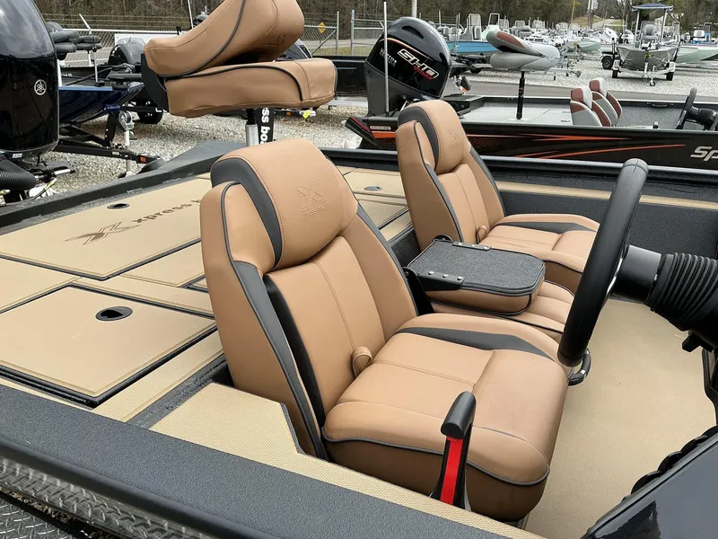 Slide: The Image of 2025 Xpress Hyper-Lift Bass Series boat interior with tan and black seating. - 5