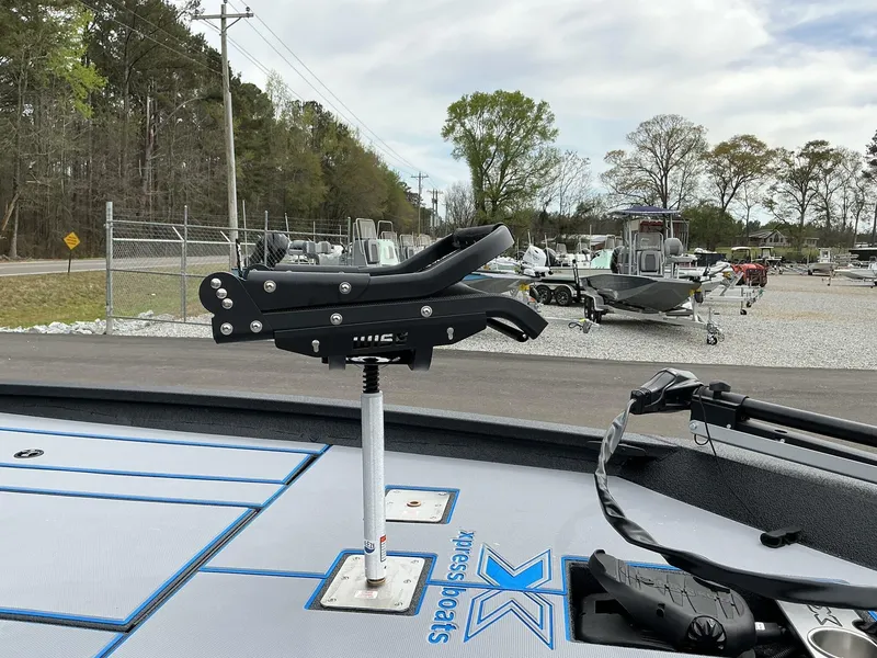Slide: The Image of 2025 Xpress Hyper-Lift Crappie Series H20 boat with fishing rod holder, parked in a lot. - 6