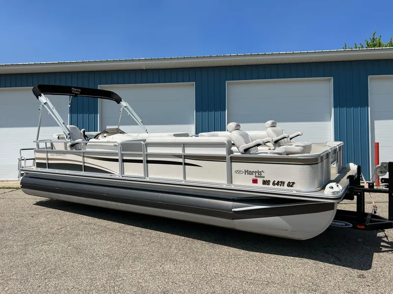 The Image of 2006 Harris FloteBote 250 Super Sunliner pontoon boat parked near blue garage. - 0