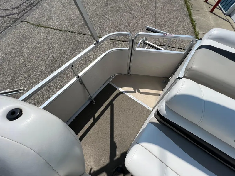 Slide: The Image of 2006 Harris FloteBote 250 Super Sunliner interior with white seating and metal railings. - 13