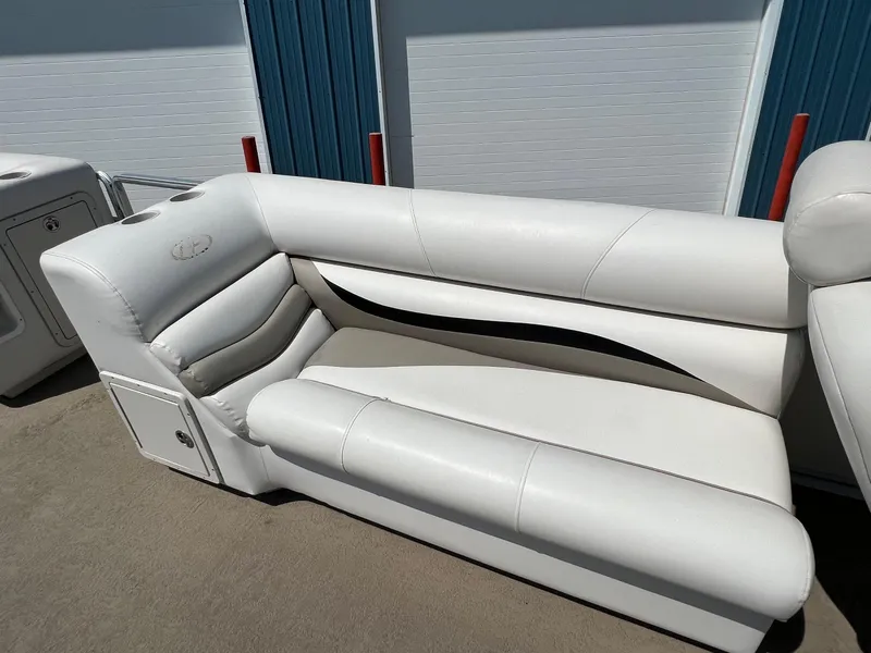 Slide: The Image of 2006 Harris FloteBote 250 Super Sunliner white boat seating, outdoor setting. - 22