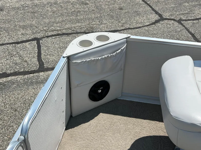 Slide: The Image of 2006 Harris FloteBote 250 Super Sunliner boat interior with cup holders and speaker. - 6