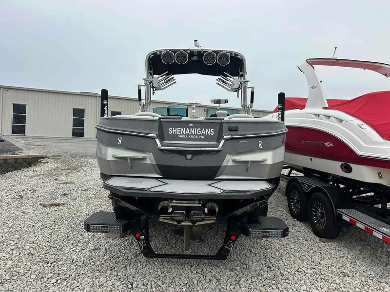 Slide: The Image of 2020 MasterCraft XStar boat parked on gravel near a building. - 3