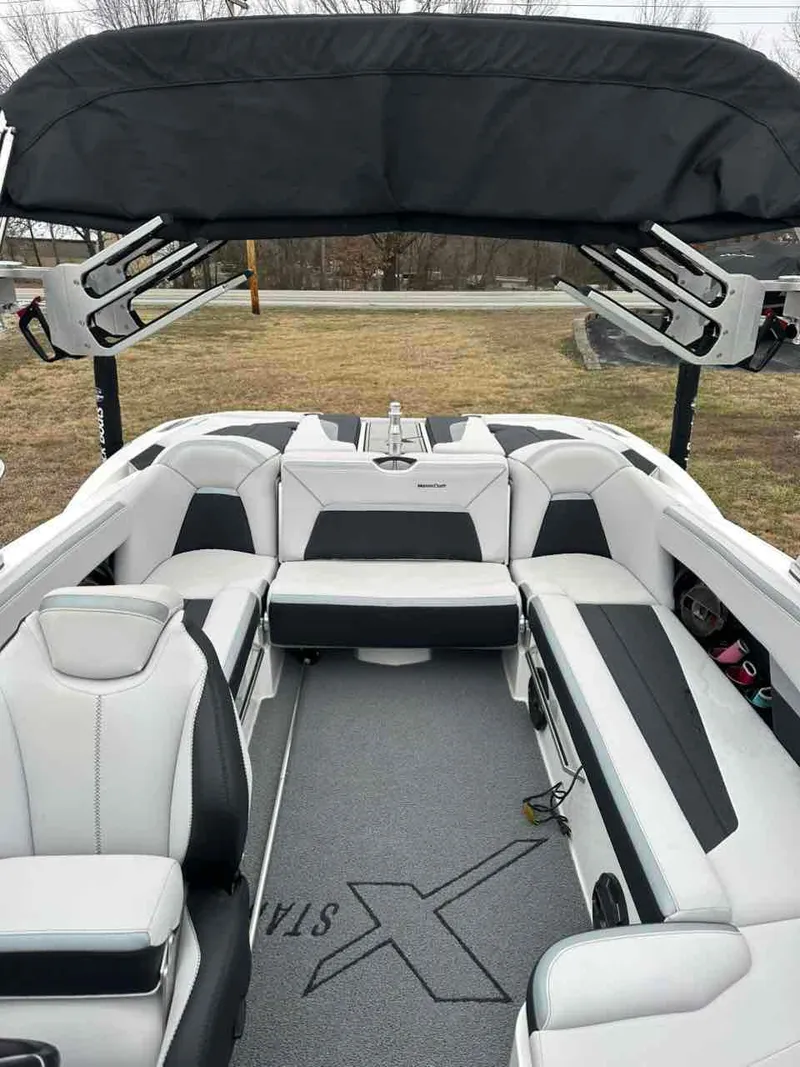 Slide: The Image of 2020 MasterCraft XStar boat interior with sleek seating and black canopy. - 6