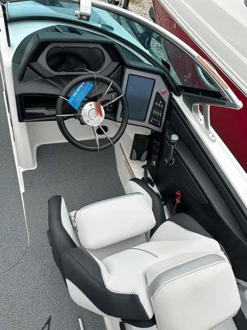 Slide: The Image of 2020 MasterCraft XStar boat cockpit with steering wheel and control panel. - 8