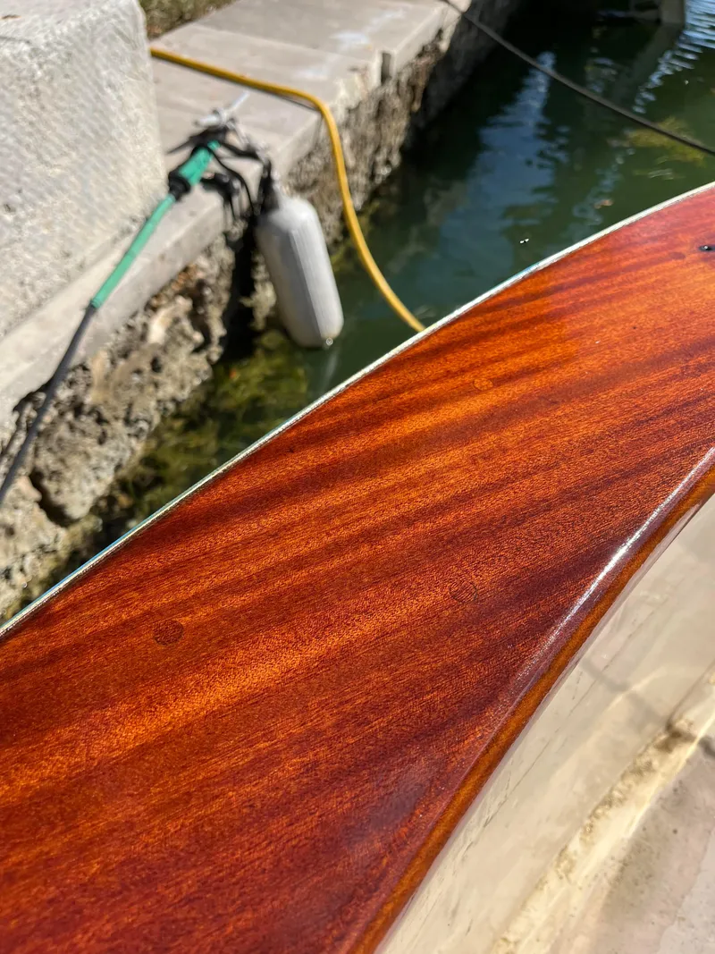 Slide: The Image of 2005 Apreamare Don Giovanni boat with polished wooden deck near a dock. - 11