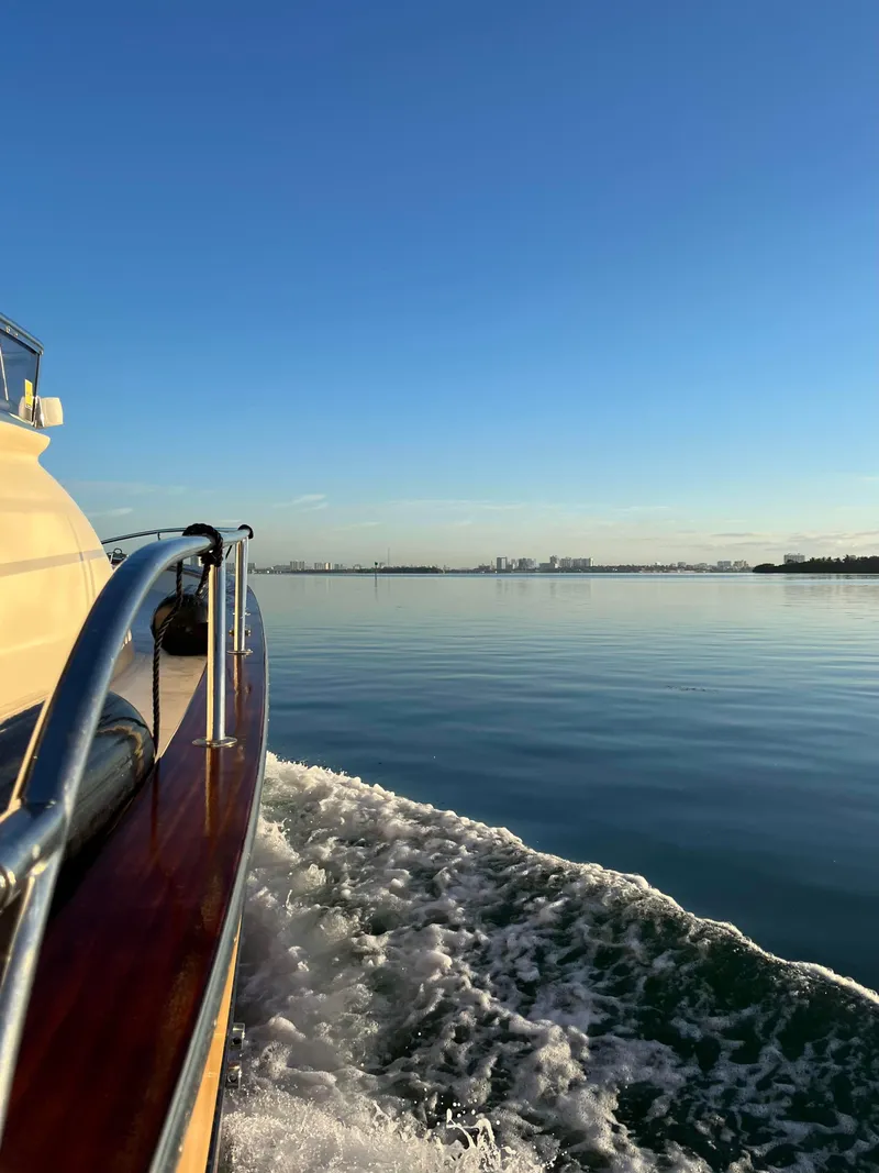 Slide: The Image of 2005 Apreamare Don Giovanni yacht cruising on calm waters under a clear blue sky. - 12