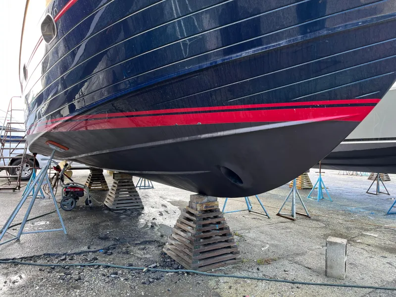 Slide: The Image of 2005 Apreamare Don Giovanni yacht on stands, showcasing hull design and vibrant colors. - 19