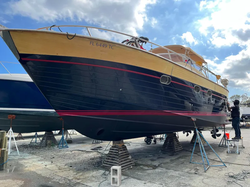 Slide: The Image of 2005 Apreamare Don Giovanni yacht on stands, under a partly cloudy sky. - 22