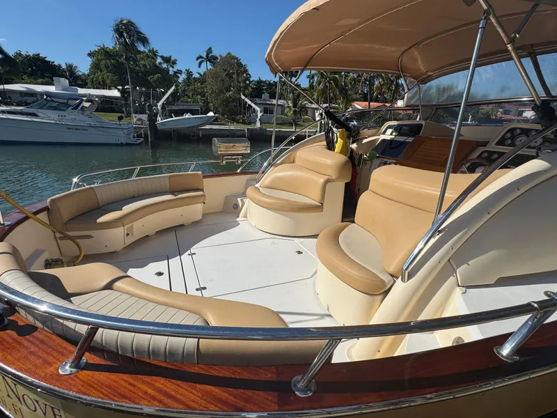 Slide: The Image of 2005 Apreamare Don Giovanni yacht with spacious seating and elegant design in a marina setting. - 4