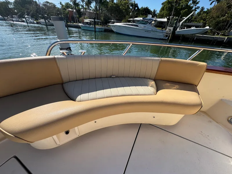 Slide: The Image of 2005 Apreamare Don Giovanni boat with curved seating, docked by the water. - 48