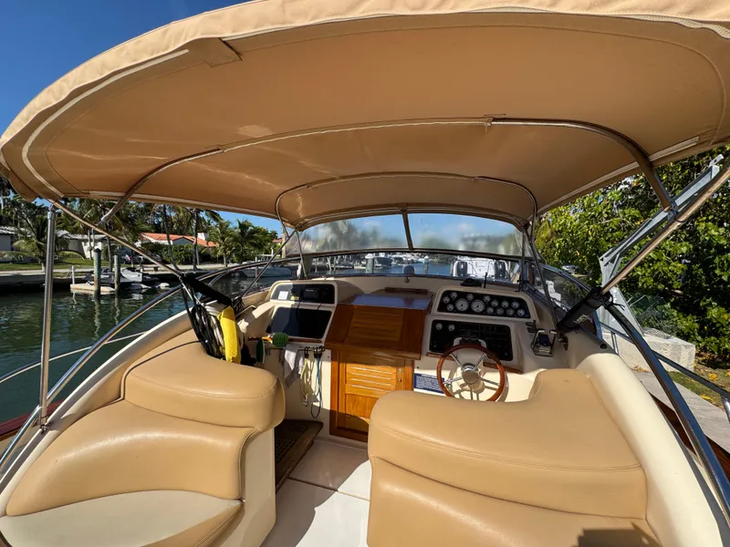 Slide: The Image of 2005 Apreamare Don Giovanni boat interior with tan seating and control panel. - 5