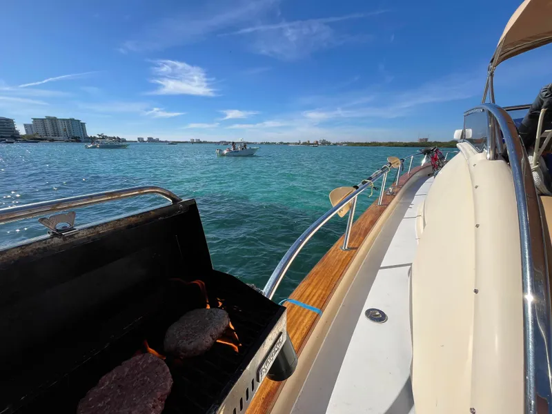 Slide: The Image of 2005 Apreamare Don Giovanni yacht with grill, cruising on clear blue waters under a sunny sky. - 8