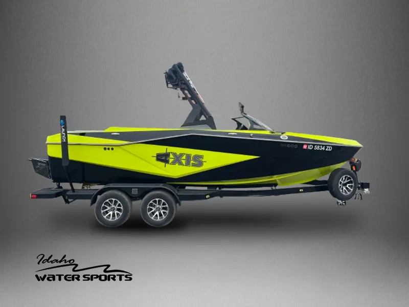 Slide: The Image of 2023 Axis T220 boat in vibrant yellow and black on trailer, Idaho Water Sports logo. - 1