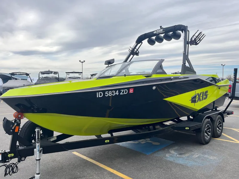 Slide: The Image of 2023 Axis T220 boat in vibrant green and black on a trailer. - 10