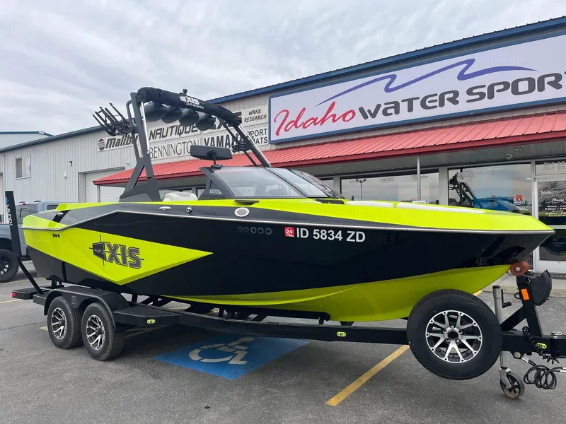 Slide: The Image of 2023 Axis T220 boat in vibrant yellow and black, parked at Idaho Water Sports. - 14