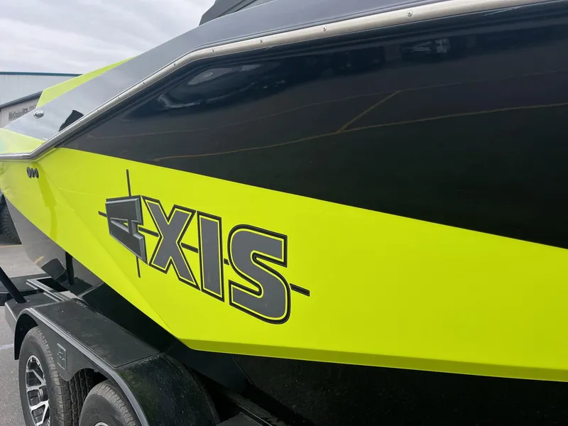 Slide: The Image of 2023 Axis T220 boat with vibrant yellow and black design on a trailer. - 15