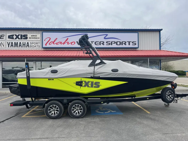 Slide: The Image of 2023 Axis T220 boat with cover on trailer at Idaho Water Sports dealership. - 2