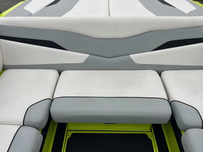 Slide: The Image of 2023 Axis T220 boat interior with gray and white cushioned seating. - 23