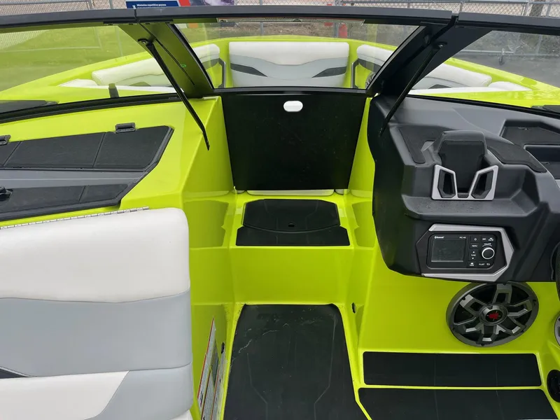 Slide: The Image of 2023 Axis T220 boat interior with vibrant lime green accents and modern dashboard controls. - 30