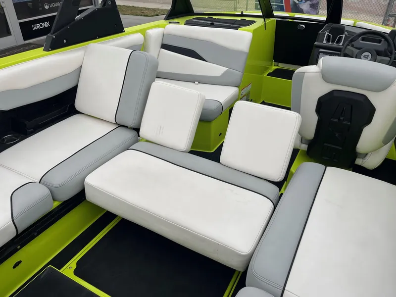 Slide: The Image of 2023 Axis T220 boat interior with white and gray seating, lime green accents. - 34