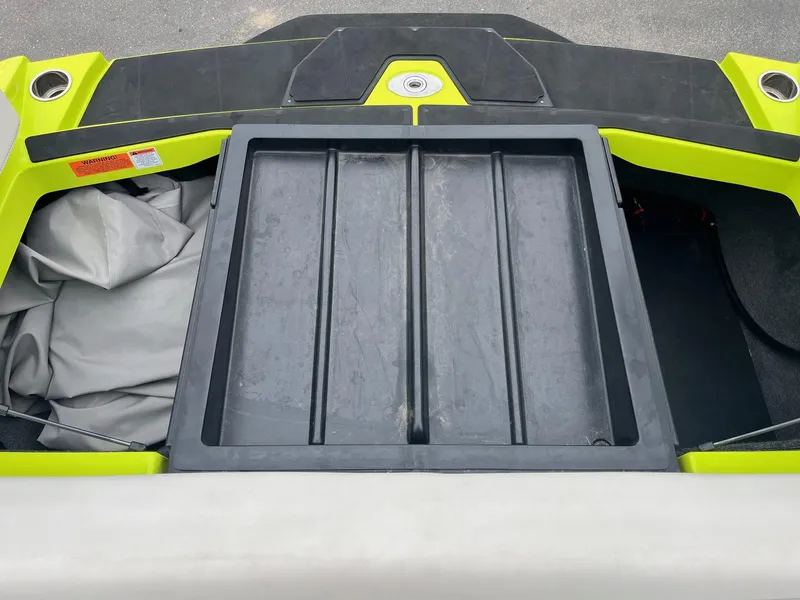 Slide: The Image of 2023 Axis T220 boat storage compartment with vibrant yellow accents and black tray. - 35