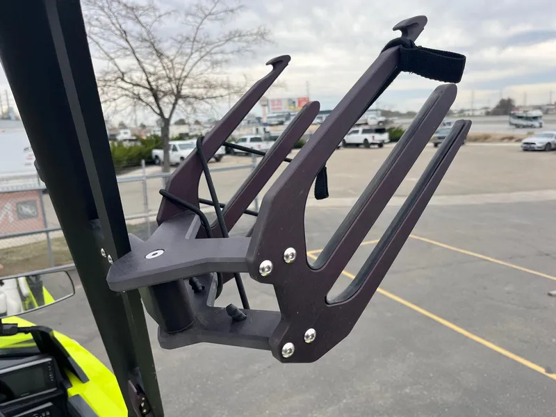 Slide: The Image of Axis T220 2023 boat accessory, black metal rack, outdoor setting, overcast sky. - 38