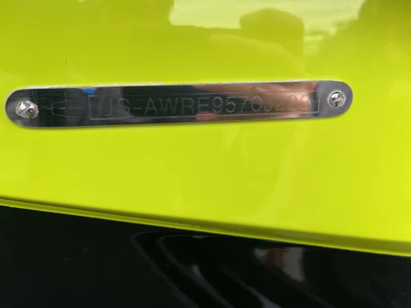 Slide: The Image of Close-up of a 2023 Axis T220 identification plate on a bright yellow surface. - 40