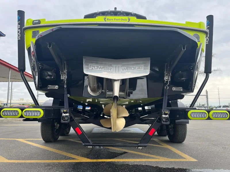 Slide: The Image of Rear view of a 2023 Axis T220 boat on a trailer, showcasing the propeller and Power Wedge. - 6