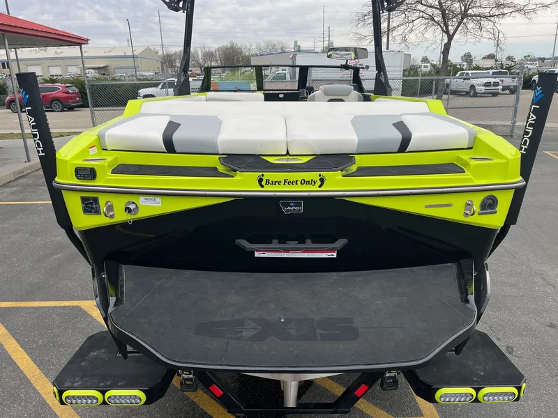 Slide: The Image of 2023 Axis T220 boat with vibrant green and black design, featuring "Bare Feet Only" decal. - 7