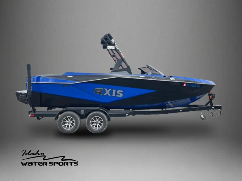 Slide: The Image of 2023 Axis T220 boat on trailer, blue and black design, Idaho Water Sports logo. - 1