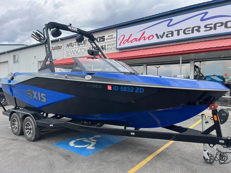 Slide: The Image of 2023 Axis T220 boat in blue and black at Idaho Water Sports dealership. - 13