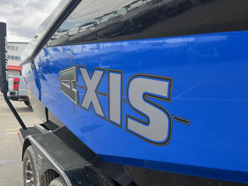 Slide: The Image of Blue 2023 Axis T220 boat with bold logo on trailer. - 14