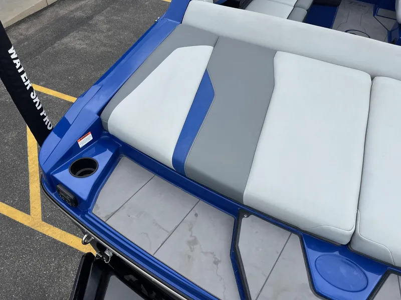 Slide: The Image of 2023 Axis T220 boat with blue and gray seating, cup holder, and sleek design. - 16