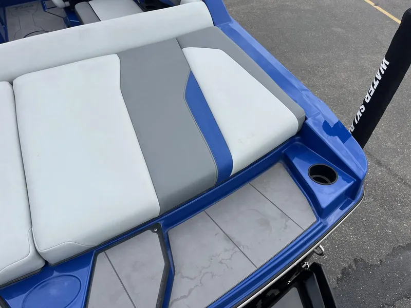 Slide: The Image of 2023 Axis T220 boat with blue and gray seating and cup holder. - 17