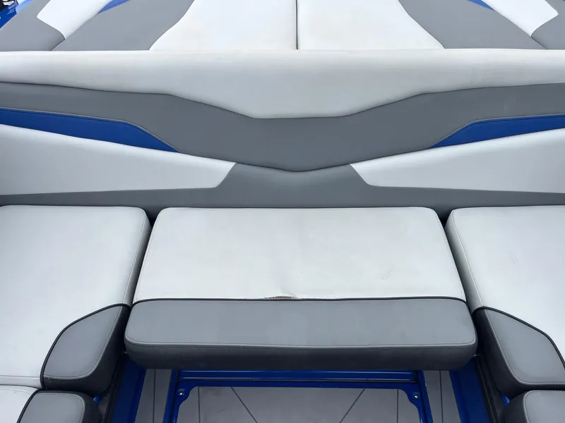 Slide: The Image of 2023 Axis T220 boat interior with gray and blue cushioned seating. - 22